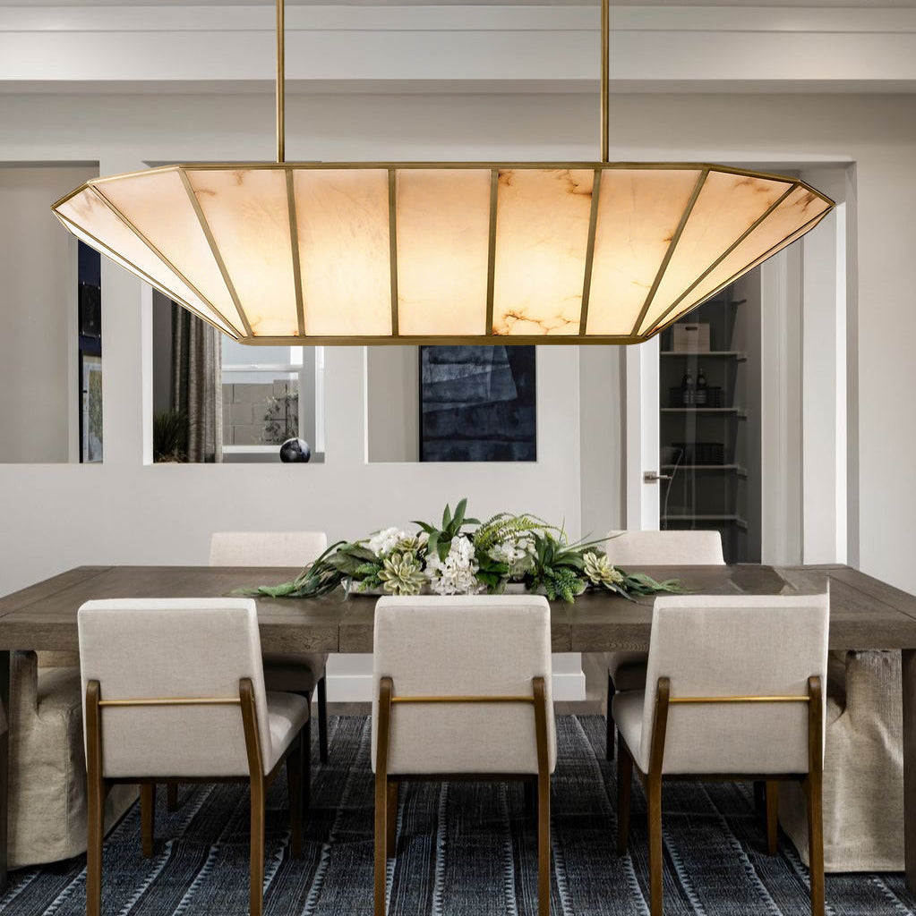 Dining room with a modern chandelier, table, and chairs.