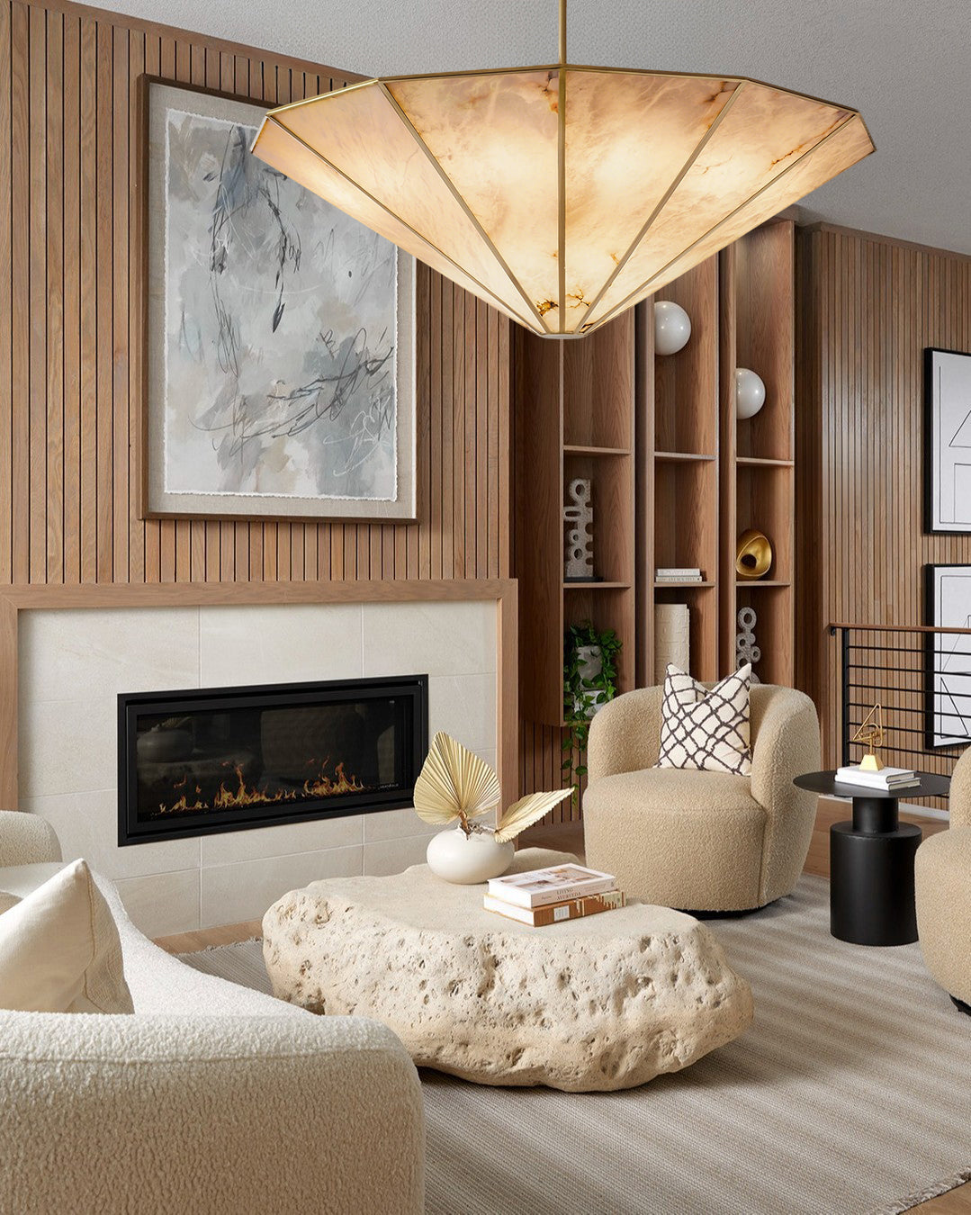 Modern living room with a fireplace, beige armchair, and decorative elements.